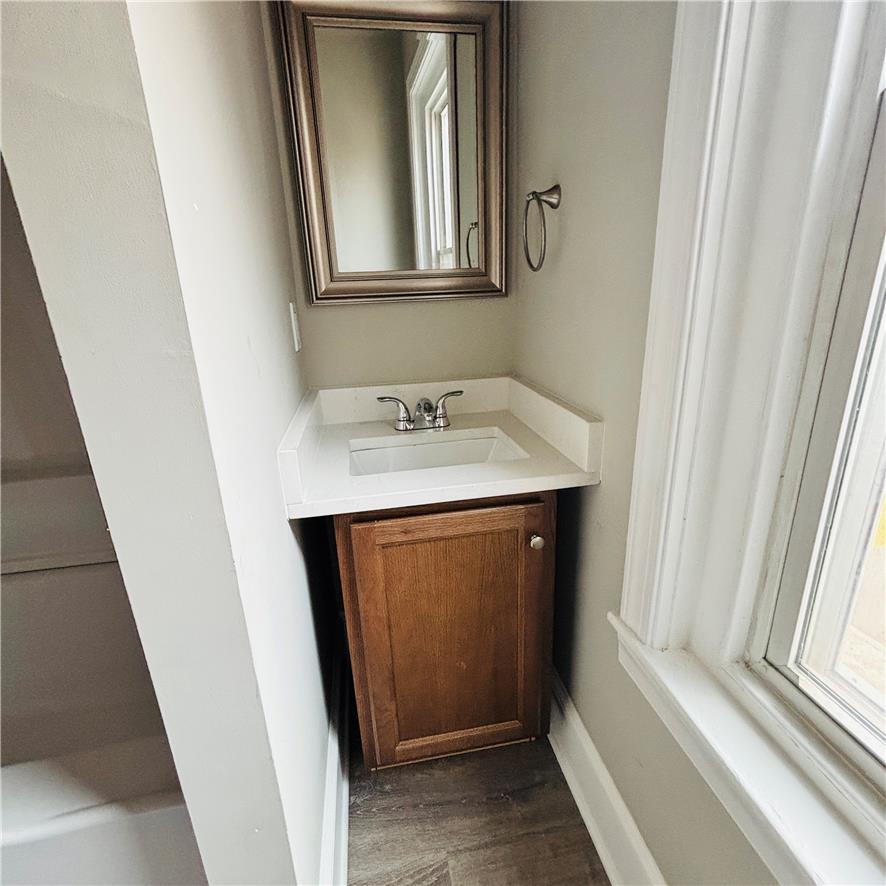 718 Linden Street Bethlehem, PA 18018 - Photo 14 of 19 A compact vanity with a pristine countertop offers practical elegance within this washroom.