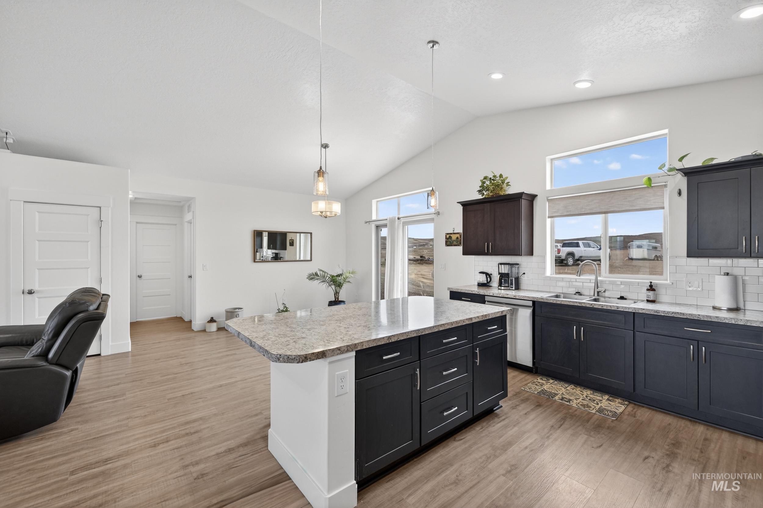 1854 Jacks Road Midvale, ID 83645 - Photo 16 of 16 Kitchen with tasteful backsplash, lofted ceiling, open floor plan, light wood-style flooring, and dishwasher