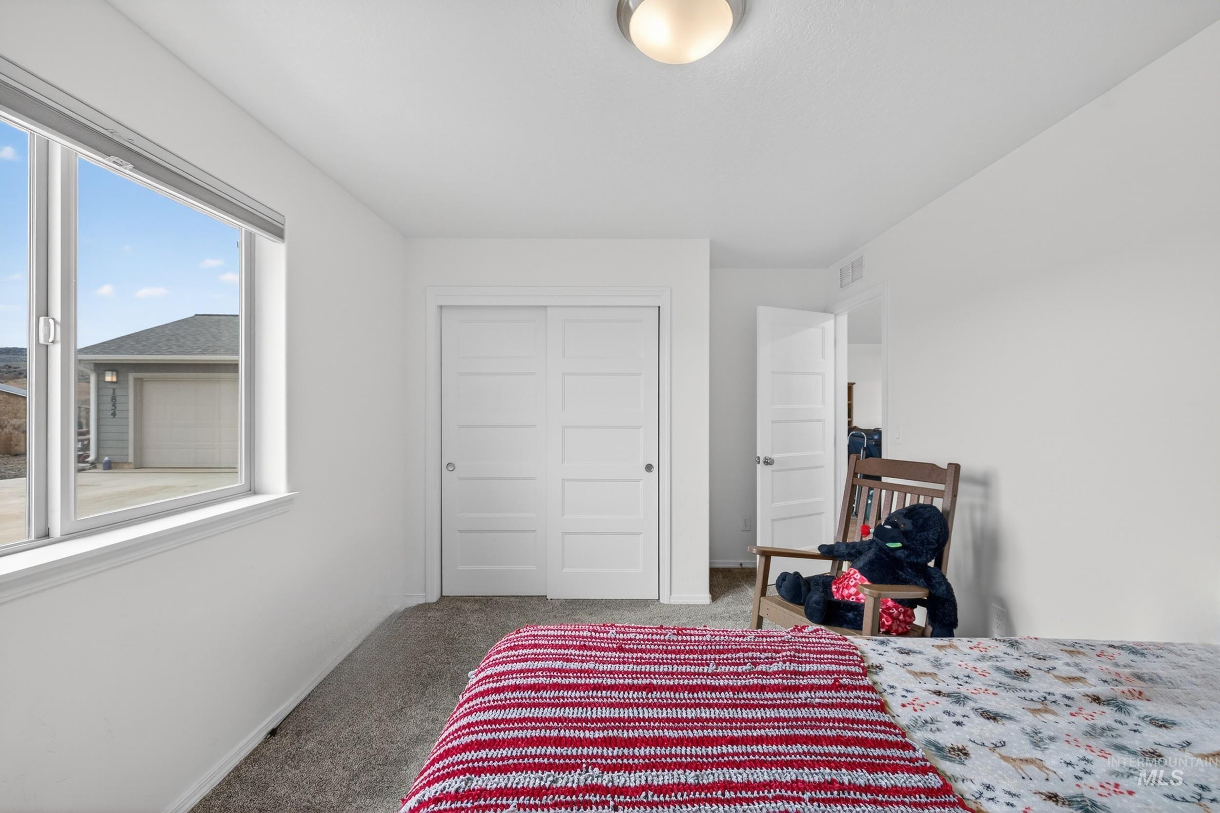1854 Jacks Road Midvale, ID 83645 - Photo 7 of 16 Bedroom featuring light colored carpet and a closet