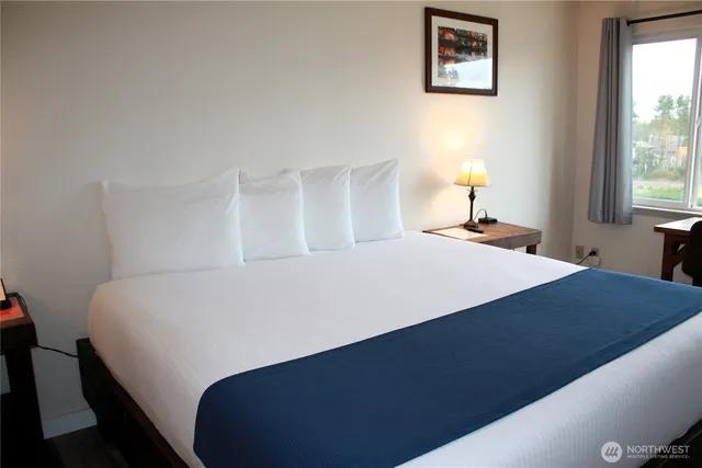 a bed sitting in a bedroom next to a window