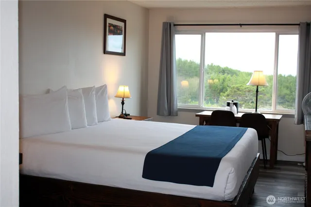 a bedroom with a bed and a large window