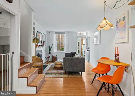 a living room with patio furniture and a wooden floor
