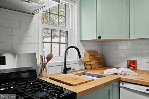 a kitchen with a sink and a stove top oven