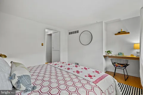 a bedroom with a bed and a table in it