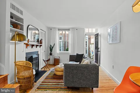 a living room with furniture fireplace and flat screen tv