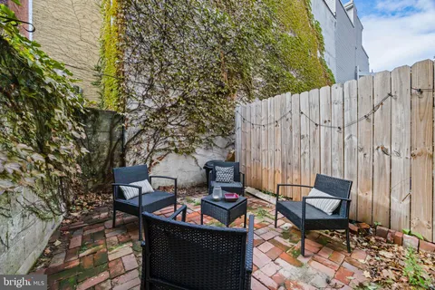 a backyard of a house with outdoor seating
