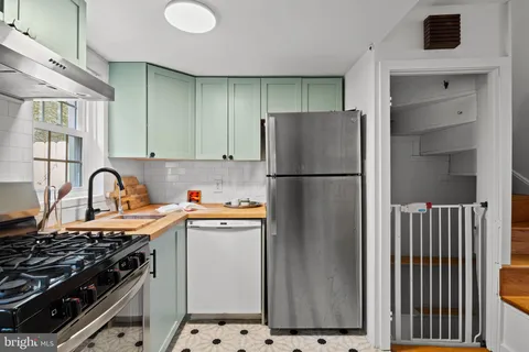 a kitchen with a stove and a refrigerator