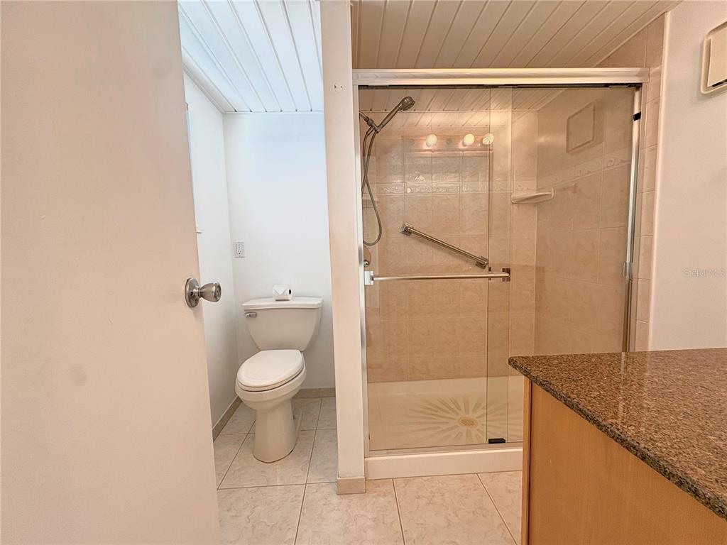 440 Denice Drive Seminole, FL 33772 - Photo 22 of 40 a bathroom with a granite countertop sink toilet and shower