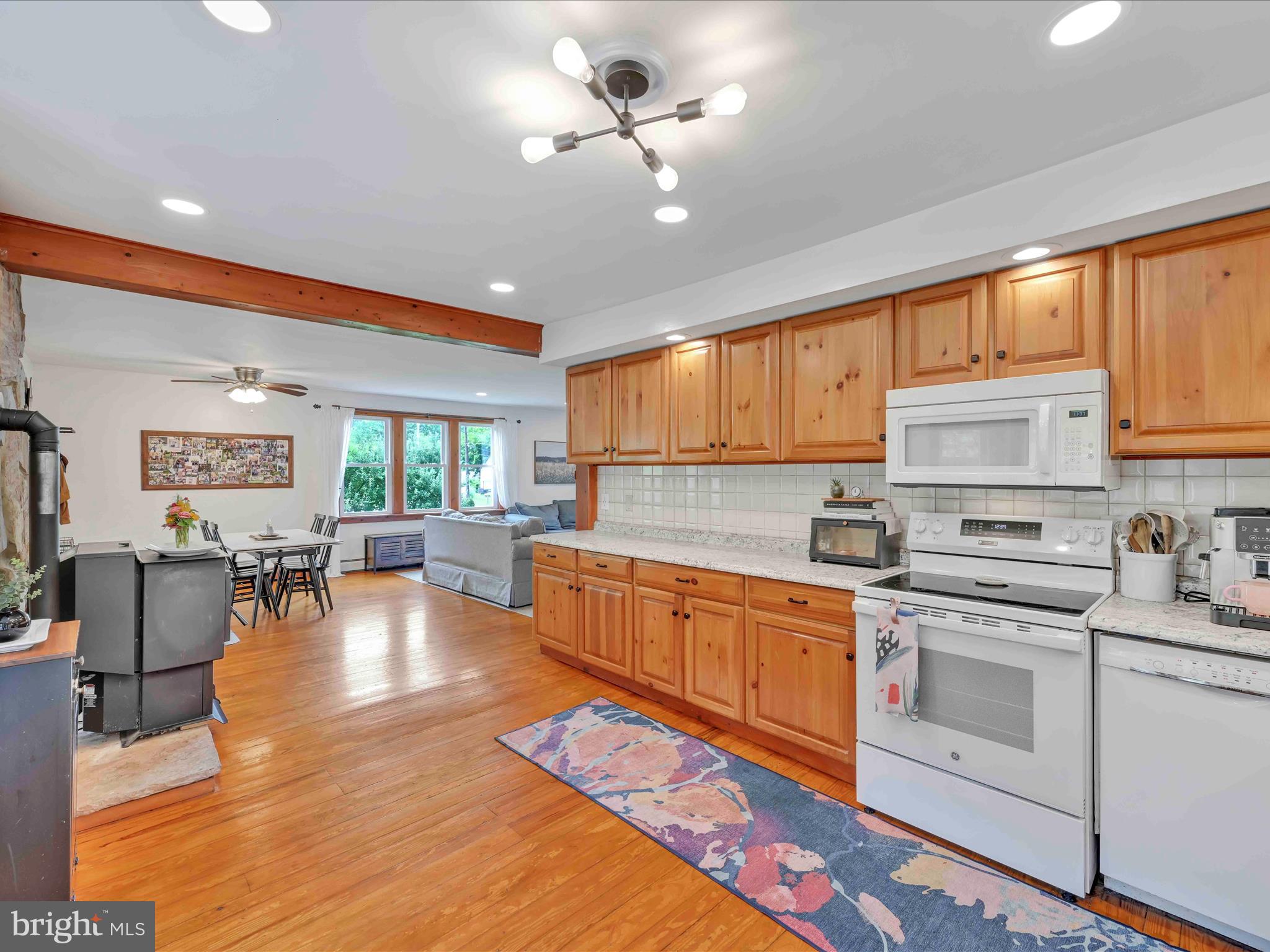 1036 Baker Road Reading, PA 19608 - Photo 15 of 44 a kitchen with stainless steel appliances granite countertop a stove sink refrigerator dining table and chairs