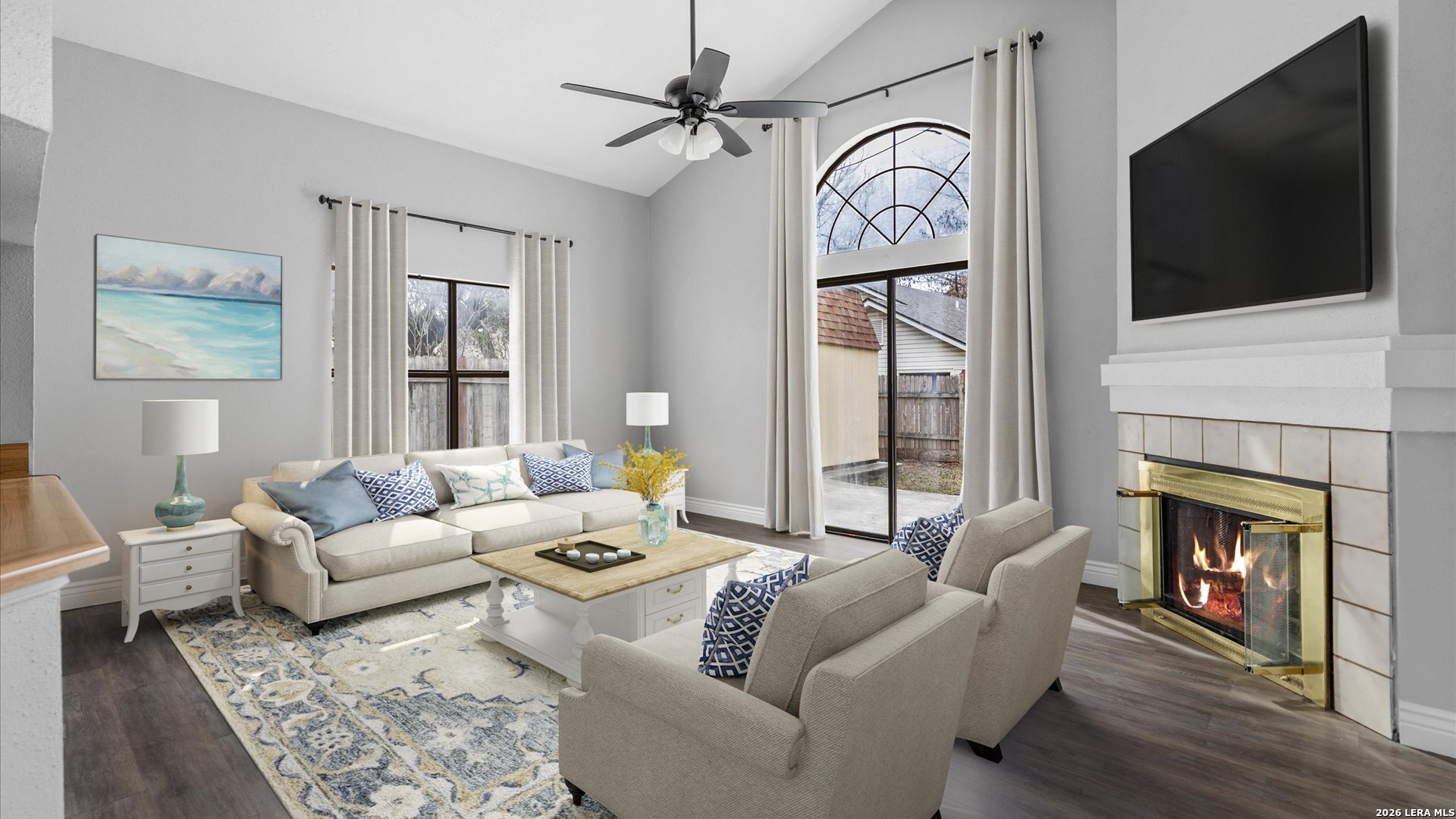 9847 Spring Harvest San Antonio, TX 78254 - Photo 11 of 27 a living room with furniture a fireplace and a flat screen tv