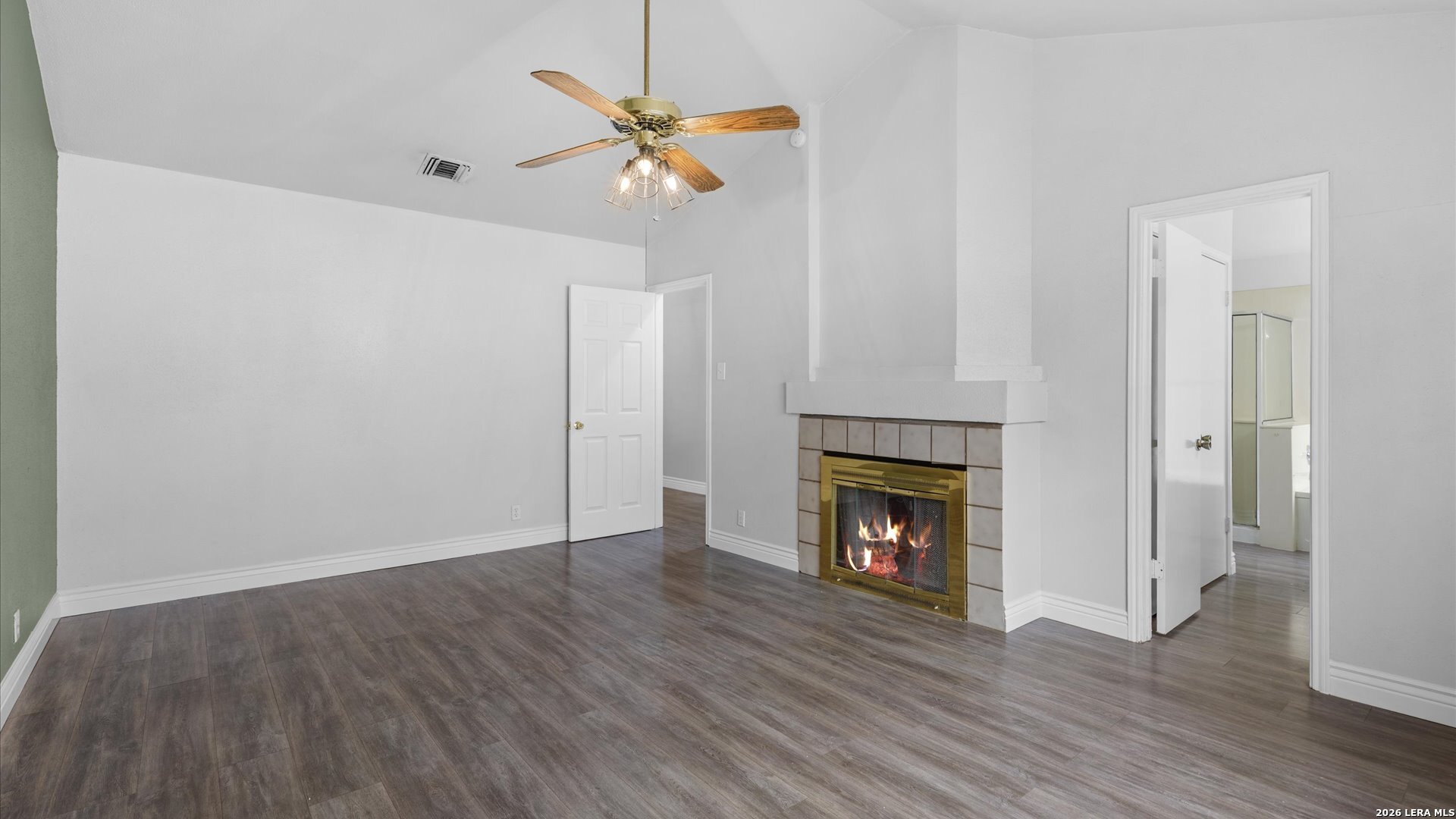 9847 Spring Harvest San Antonio, TX 78254 - Photo 13 of 27 a view of an empty room with wooden floor fireplace and a window