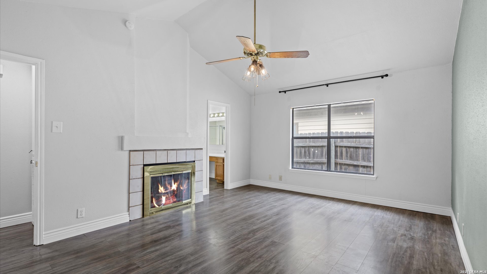 9847 Spring Harvest San Antonio, TX 78254 - Photo 16 of 27 a view of an empty room with wooden floor fireplace and a window