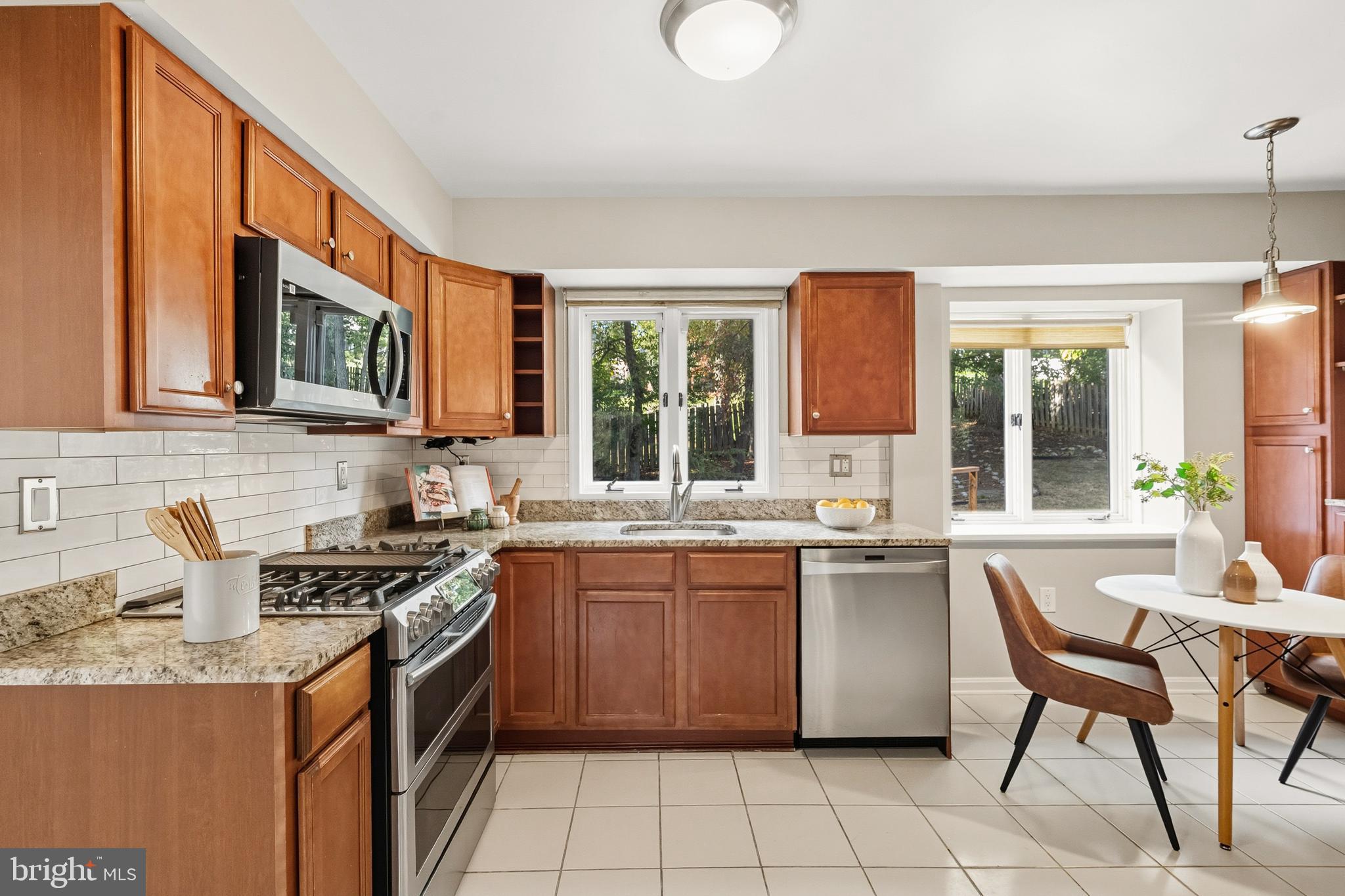 2352 Cedar Lane Vienna, VA 22182 - Photo 11 of 59 a kitchen with stainless steel appliances granite countertop a stove a sink and a microwave