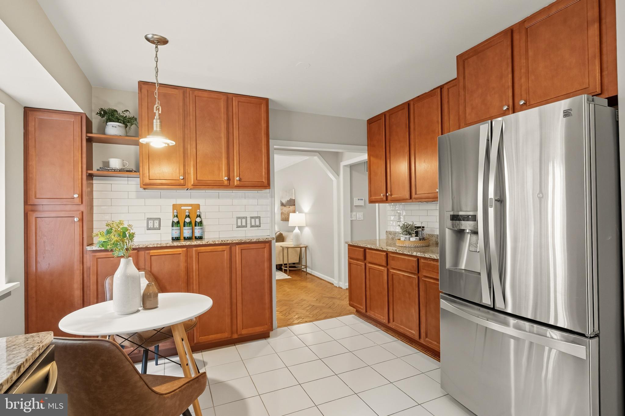 2352 Cedar Lane Vienna, VA 22182 - Photo 12 of 59 a kitchen with stainless steel appliances a refrigerator a sink a stove a dining table and chairs