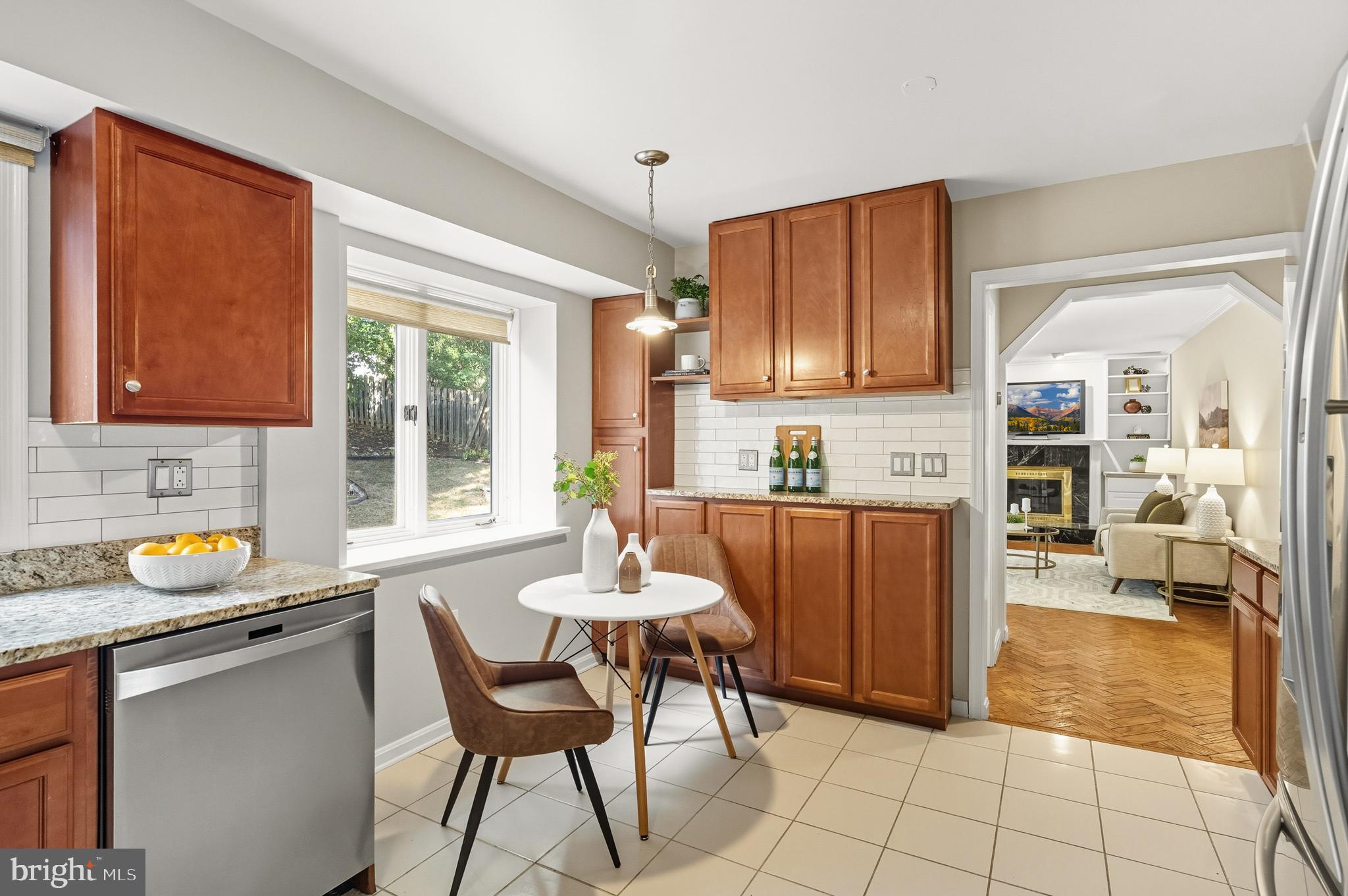2352 Cedar Lane Vienna, VA 22182 - Photo 13 of 59 a kitchen with granite countertop a refrigerator a stove a sink and a dining table with wooden cabinet