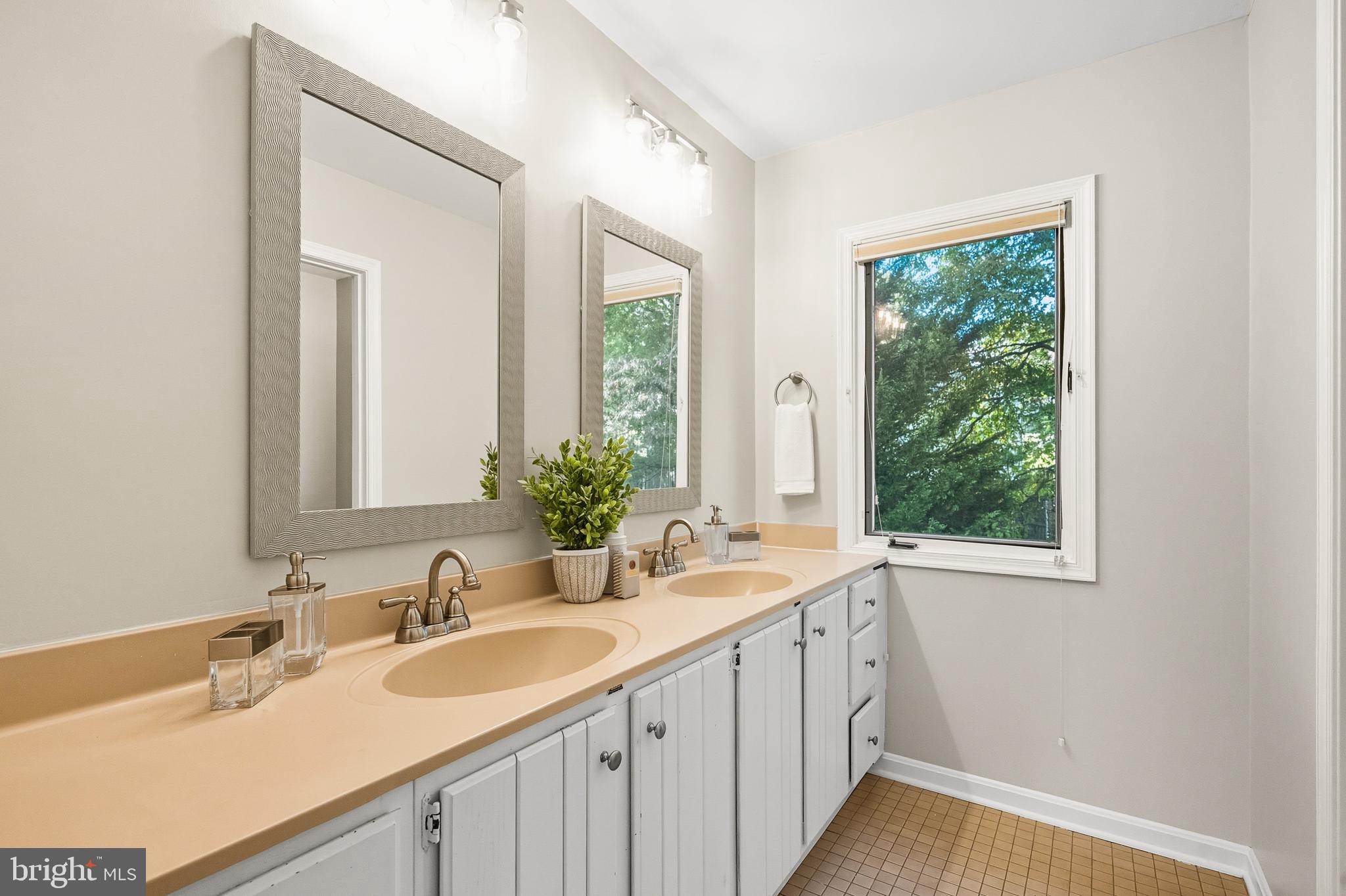 2352 Cedar Lane Vienna, VA 22182 - Photo 27 of 59 a bathroom with a double vanity sink and a mirror