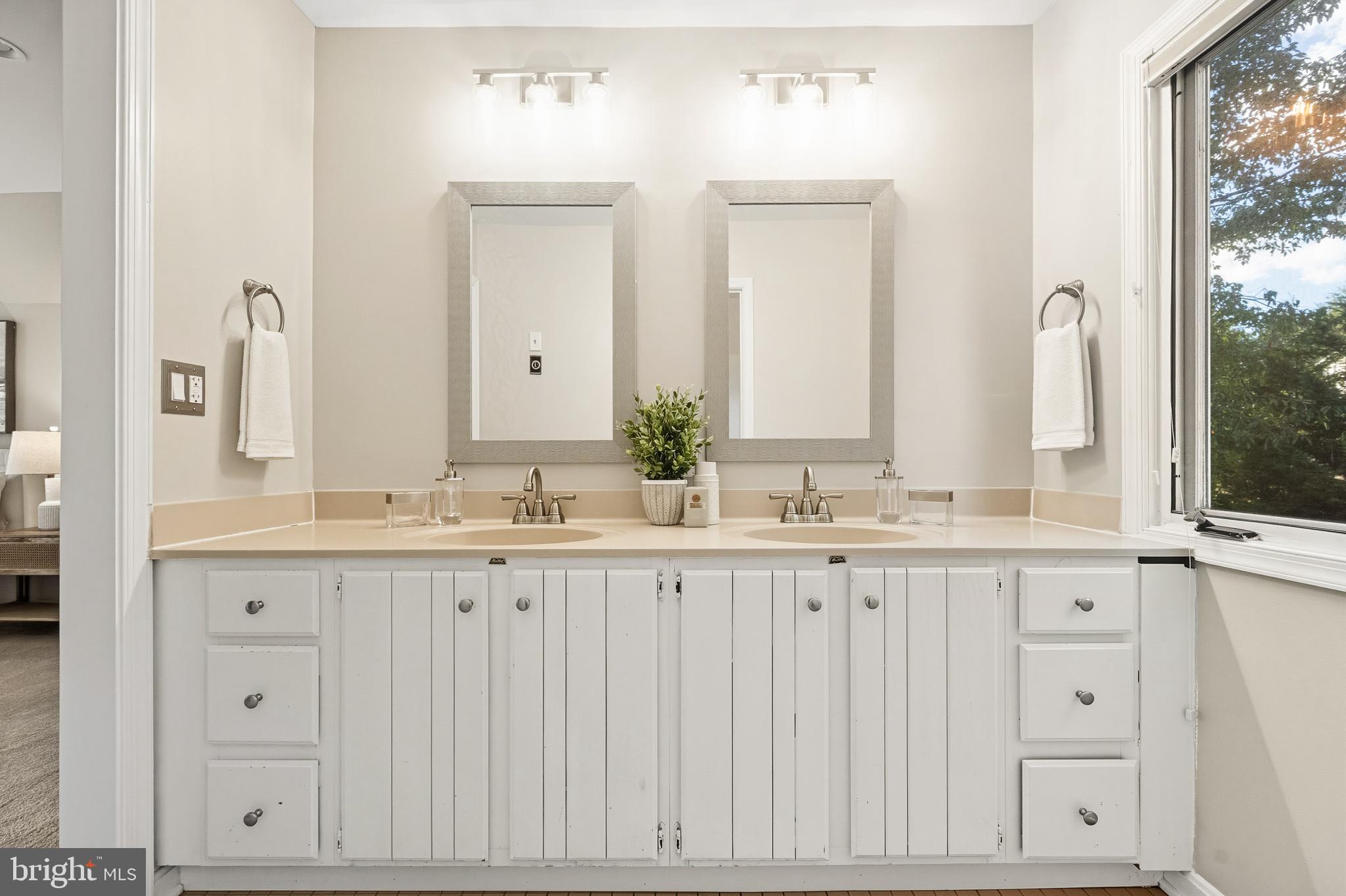 2352 Cedar Lane Vienna, VA 22182 - Photo 28 of 59 a bathroom with white cabinets and a sink