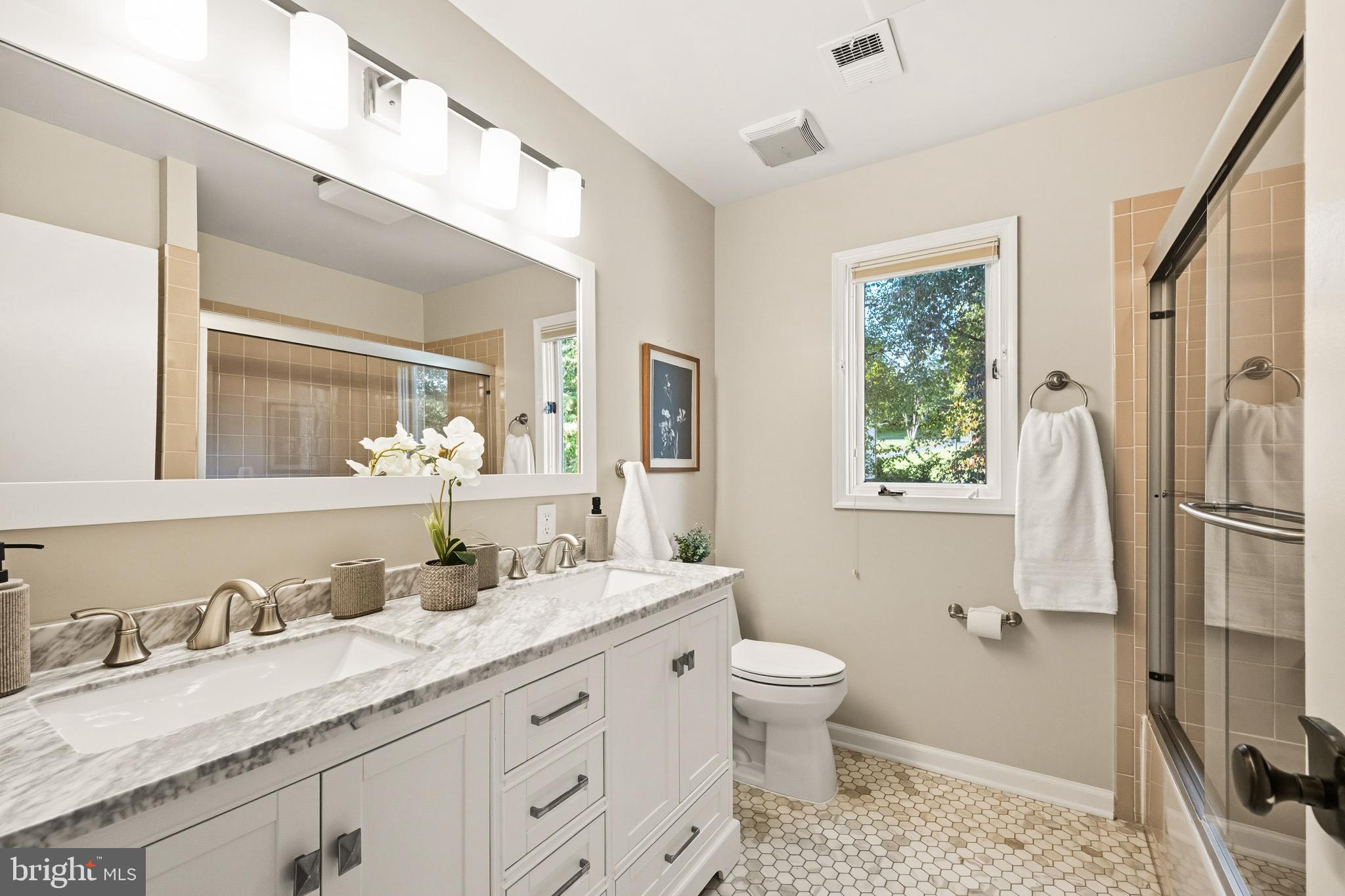 2352 Cedar Lane Vienna, VA 22182 - Photo 31 of 59 a bathroom with a granite countertop double vanity sink a mirror and a shower