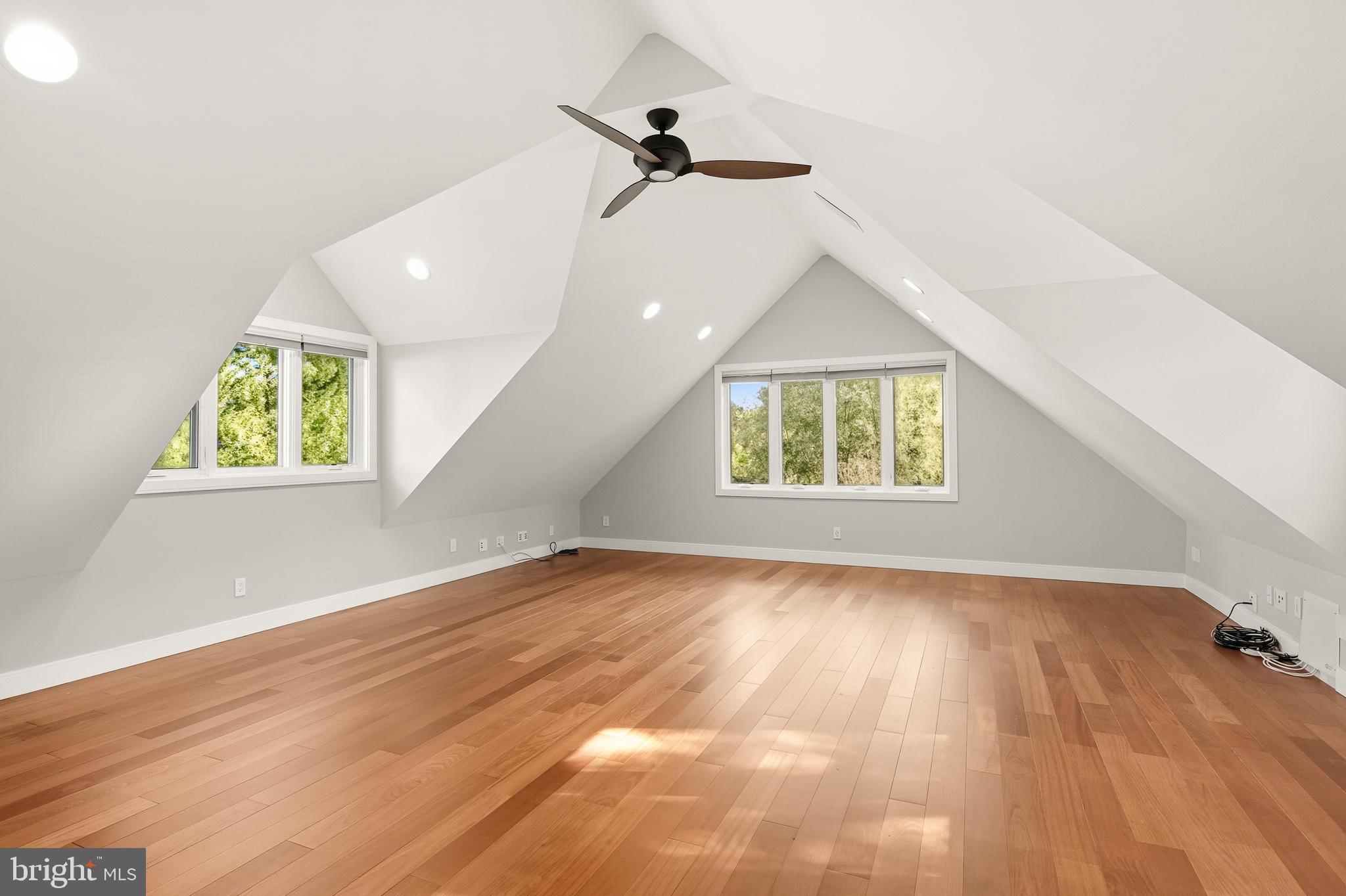 2352 Cedar Lane Vienna, VA 22182 - Photo 36 of 59 an empty room with wooden floor ceiling fan and windows