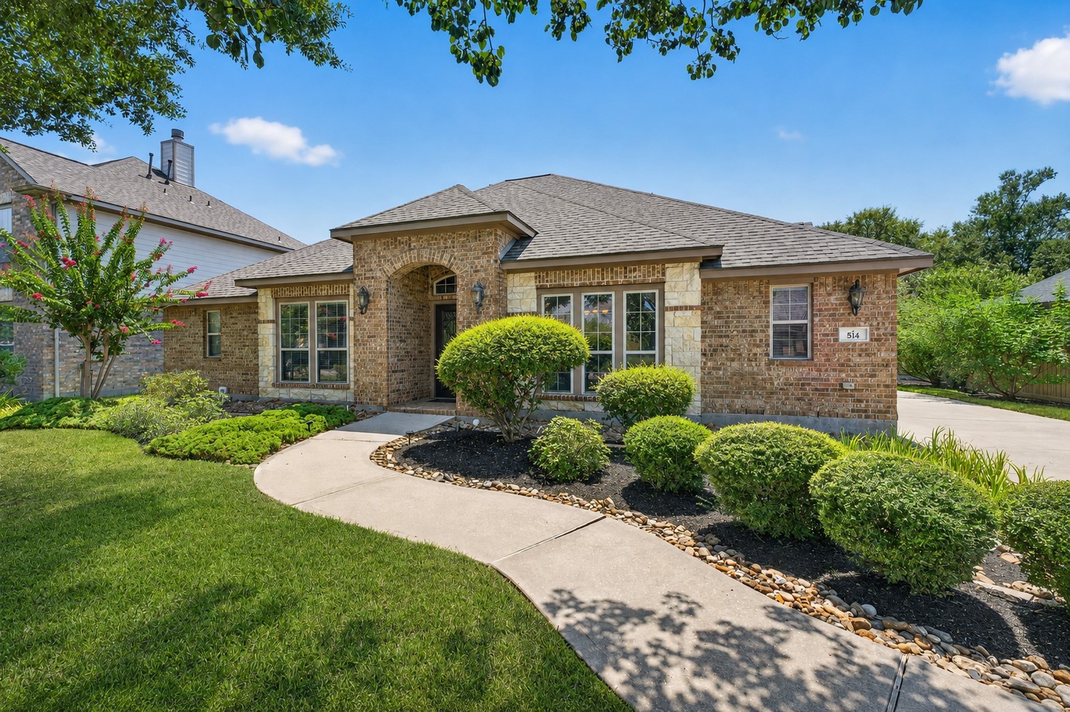An additional exterior view highlights the home’s attractive architecture and extended driveway.