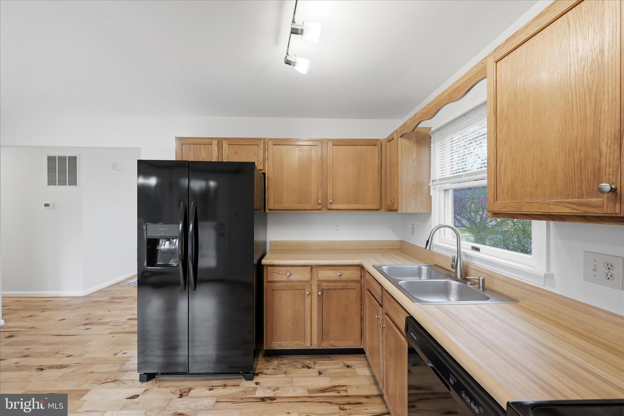 502 East 6th Avenue Ranson, WV 25438 - Photo 12 of 40 a kitchen with a sink a refrigerator and cabinets