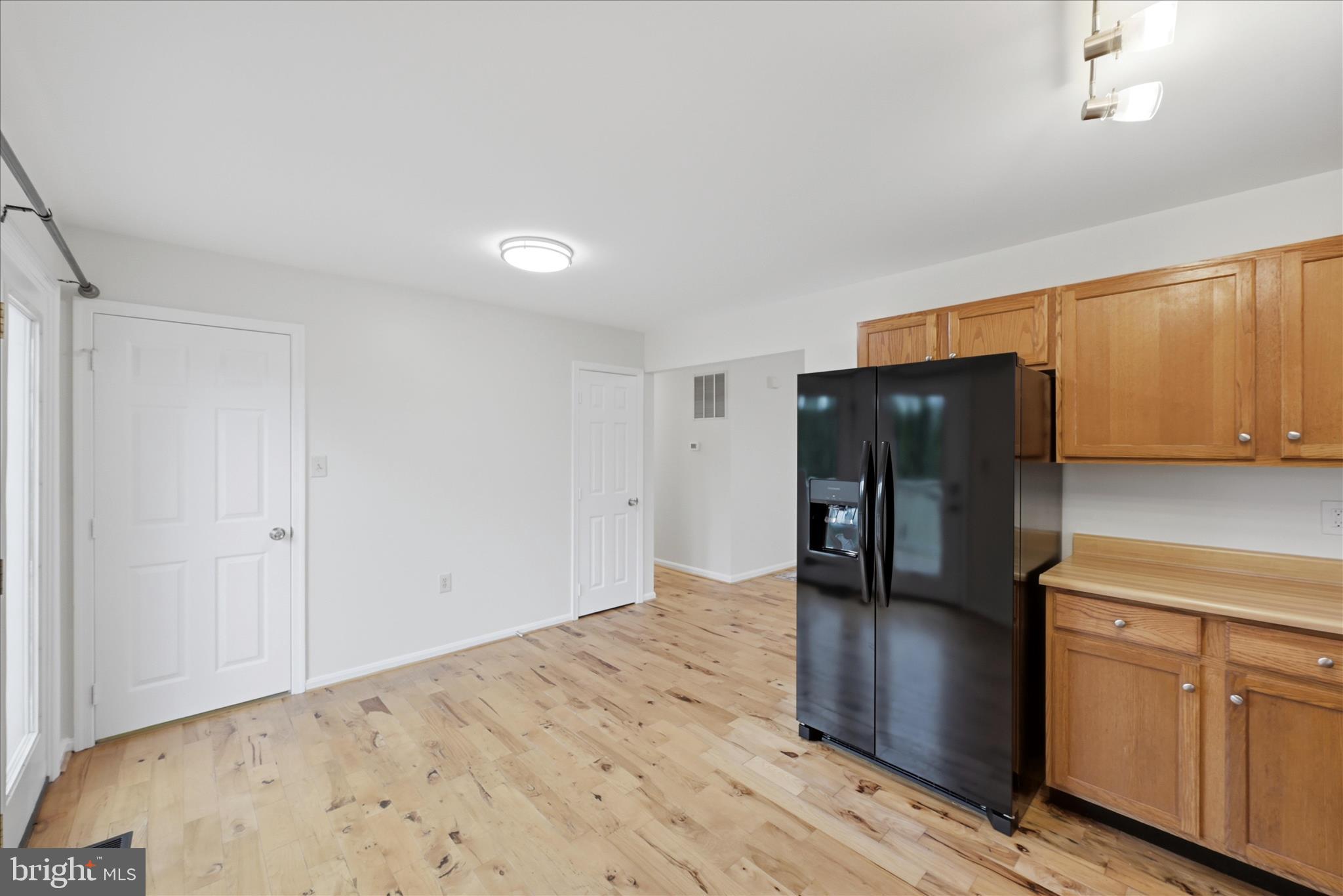 502 East 6th Avenue Ranson, WV 25438 - Photo 13 of 40 a kitchen with stainless steel appliances wooden cabinets and entryway