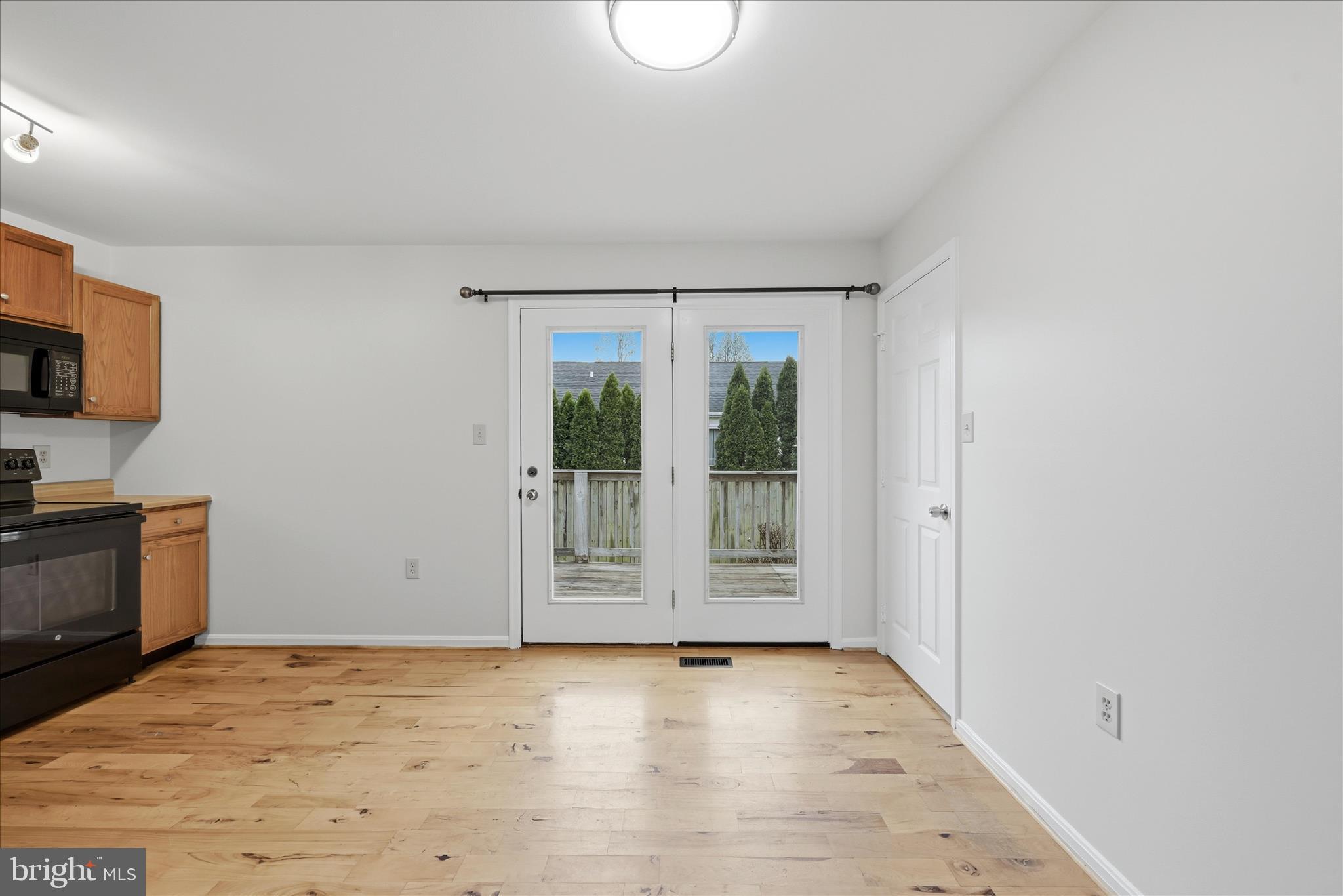502 East 6th Avenue Ranson, WV 25438 - Photo 14 of 40 a view of an empty room with a window and a kitchen