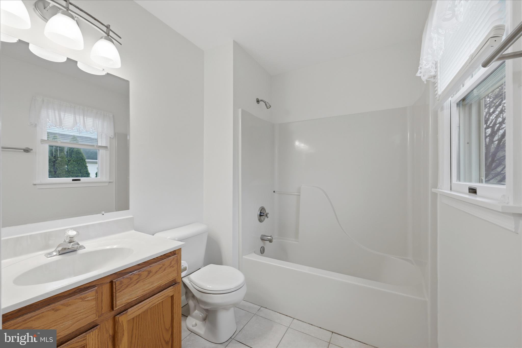502 East 6th Avenue Ranson, WV 25438 - Photo 19 of 40 a bathroom with a granite countertop sink toilet and shower