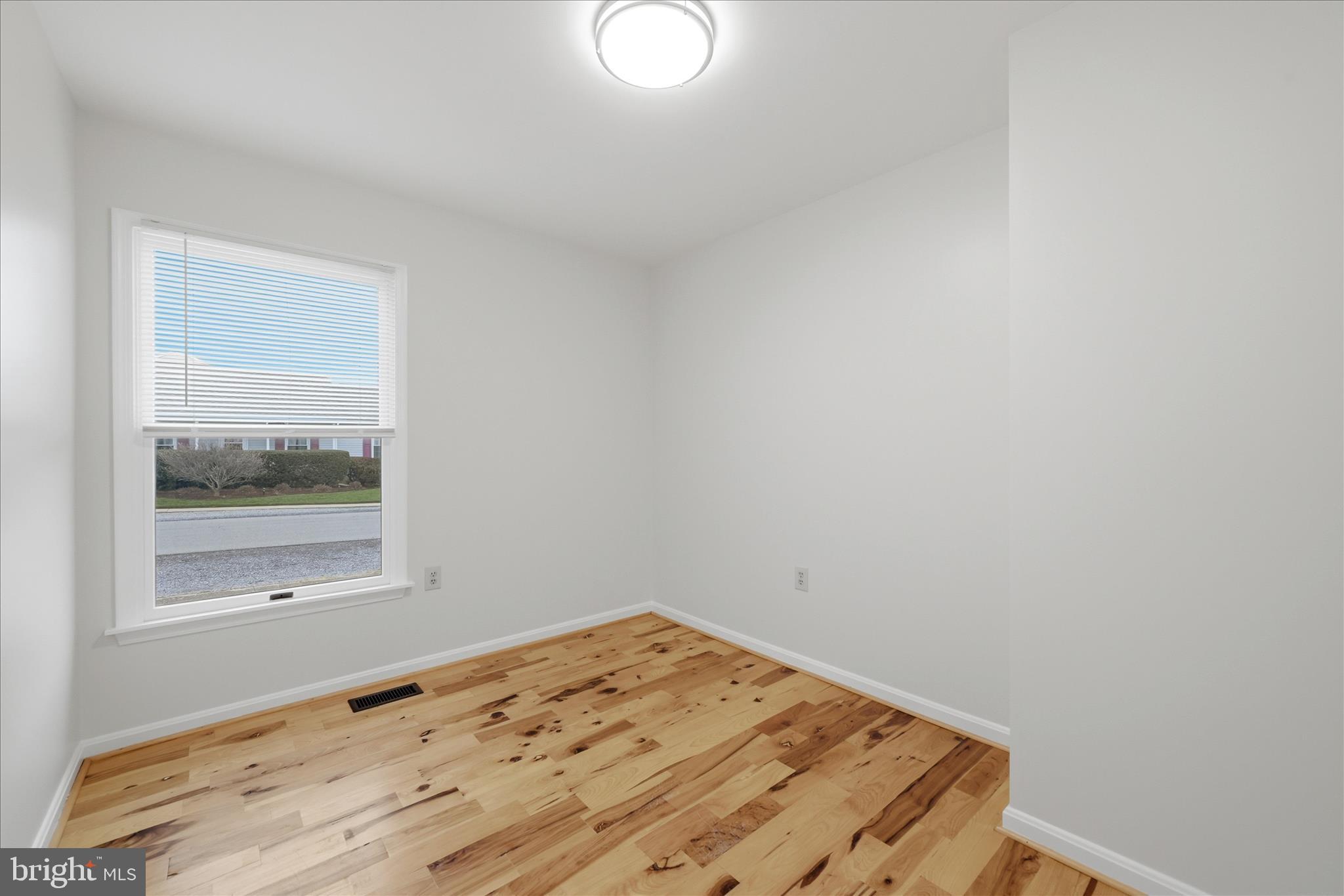 502 East 6th Avenue Ranson, WV 25438 - Photo 20 of 40 a view of a room with wooden floor and white walls