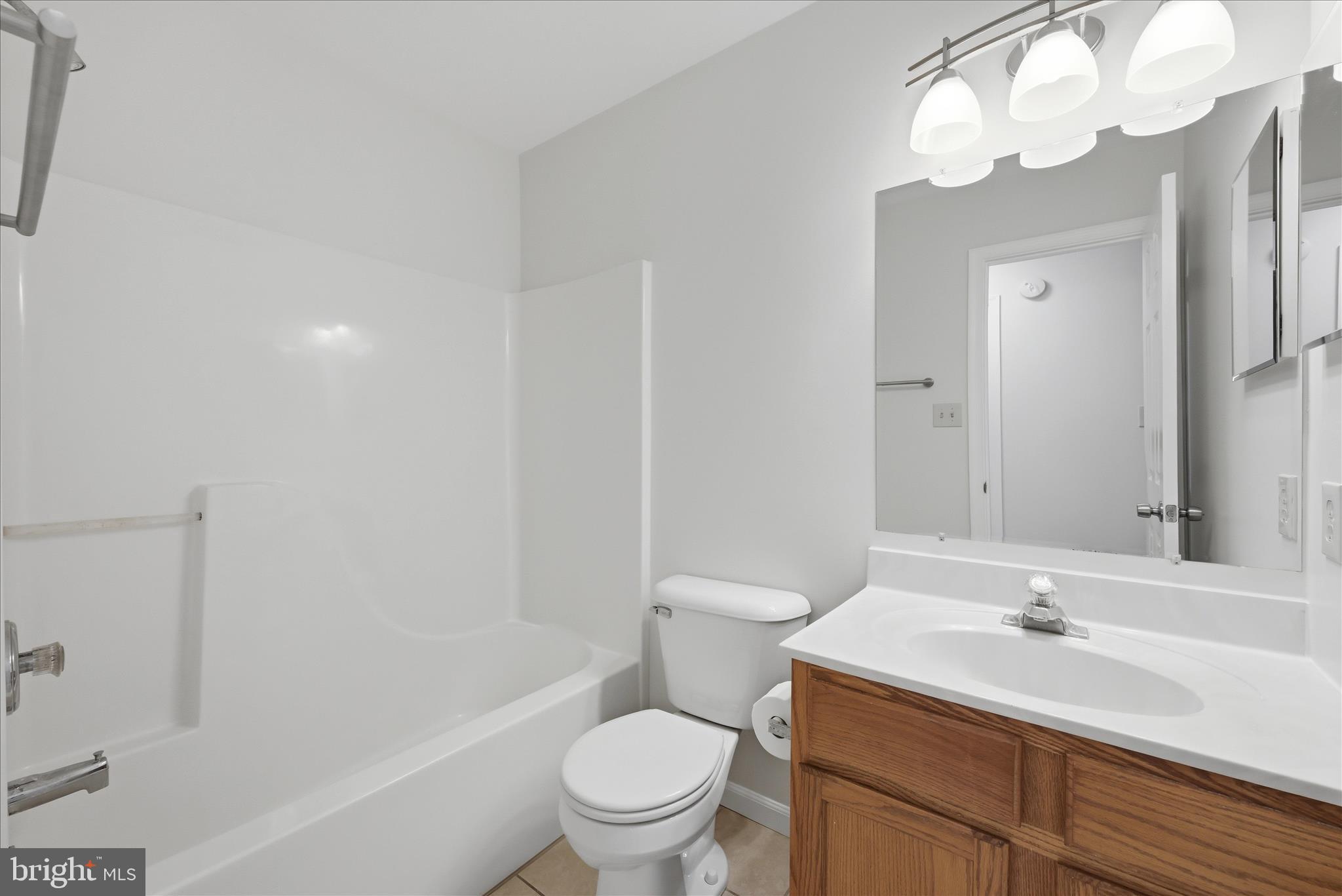 502 East 6th Avenue Ranson, WV 25438 - Photo 22 of 40 a bathroom with a sink a toilet and a large mirror