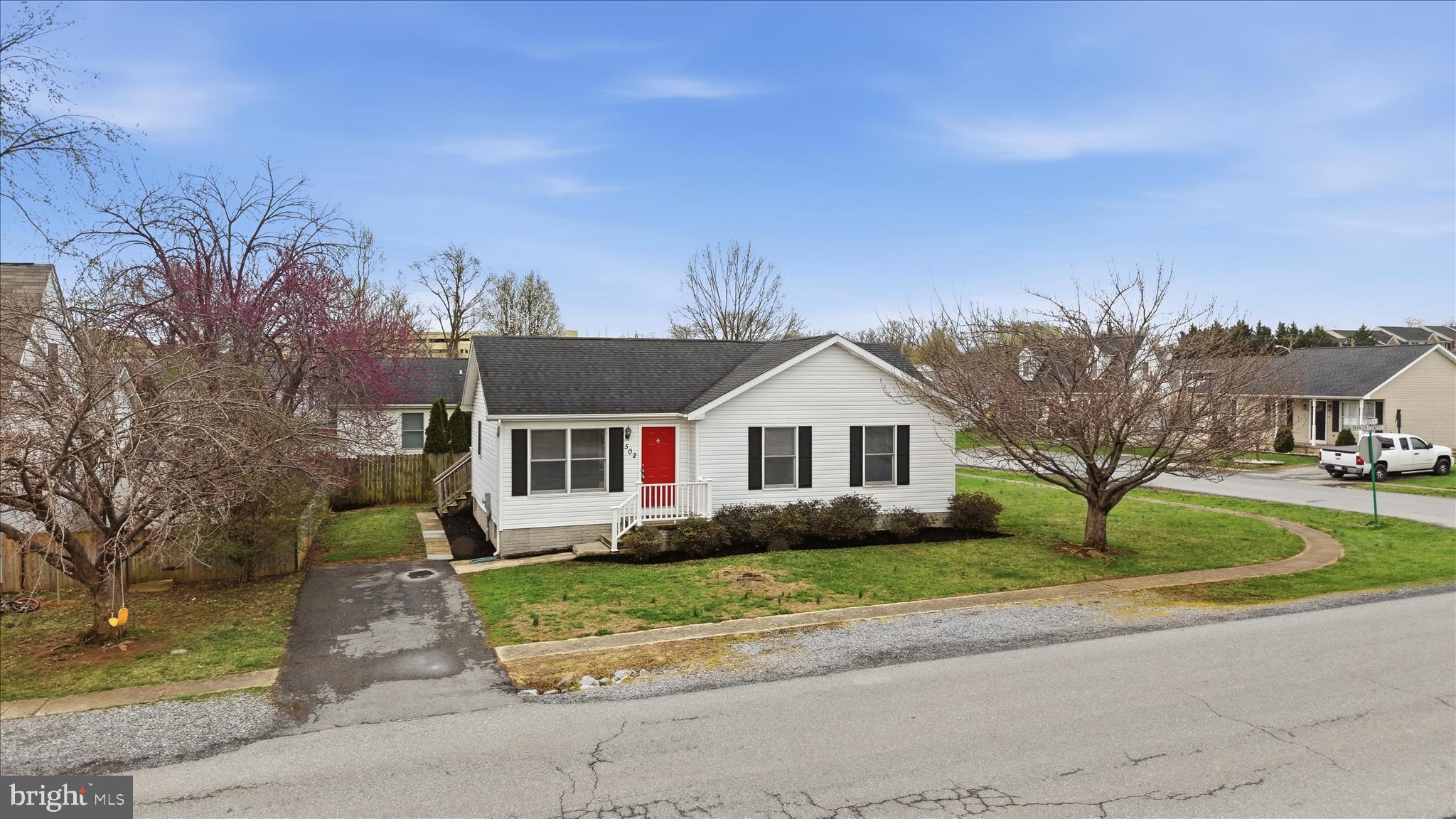 502 East 6th Avenue Ranson, WV 25438 - Photo 33 of 40 a front view of a house with a garden and trees