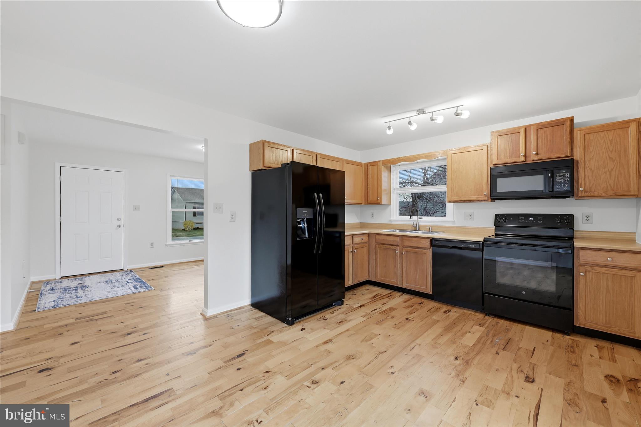 502 East 6th Avenue Ranson, WV 25438 - Photo 8 of 40 a kitchen with stainless steel appliances kitchen island granite countertop a refrigerator and a stove top oven
