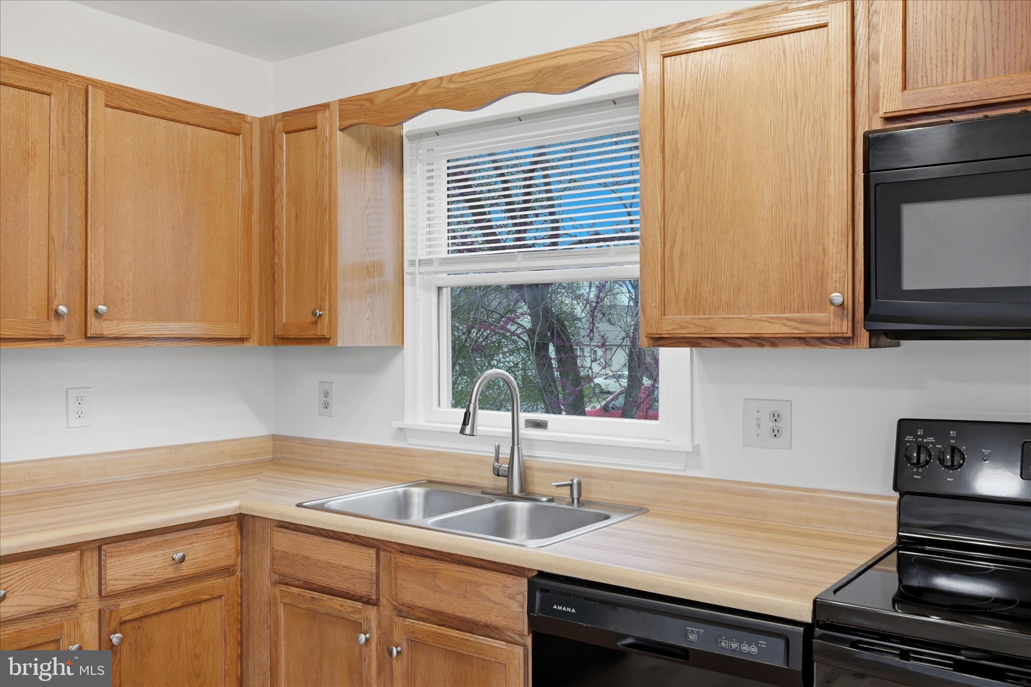 502 East 6th Avenue Ranson, WV 25438 - Photo 10 of 40 a kitchen with stainless steel appliances granite countertop a sink and a white cabinets