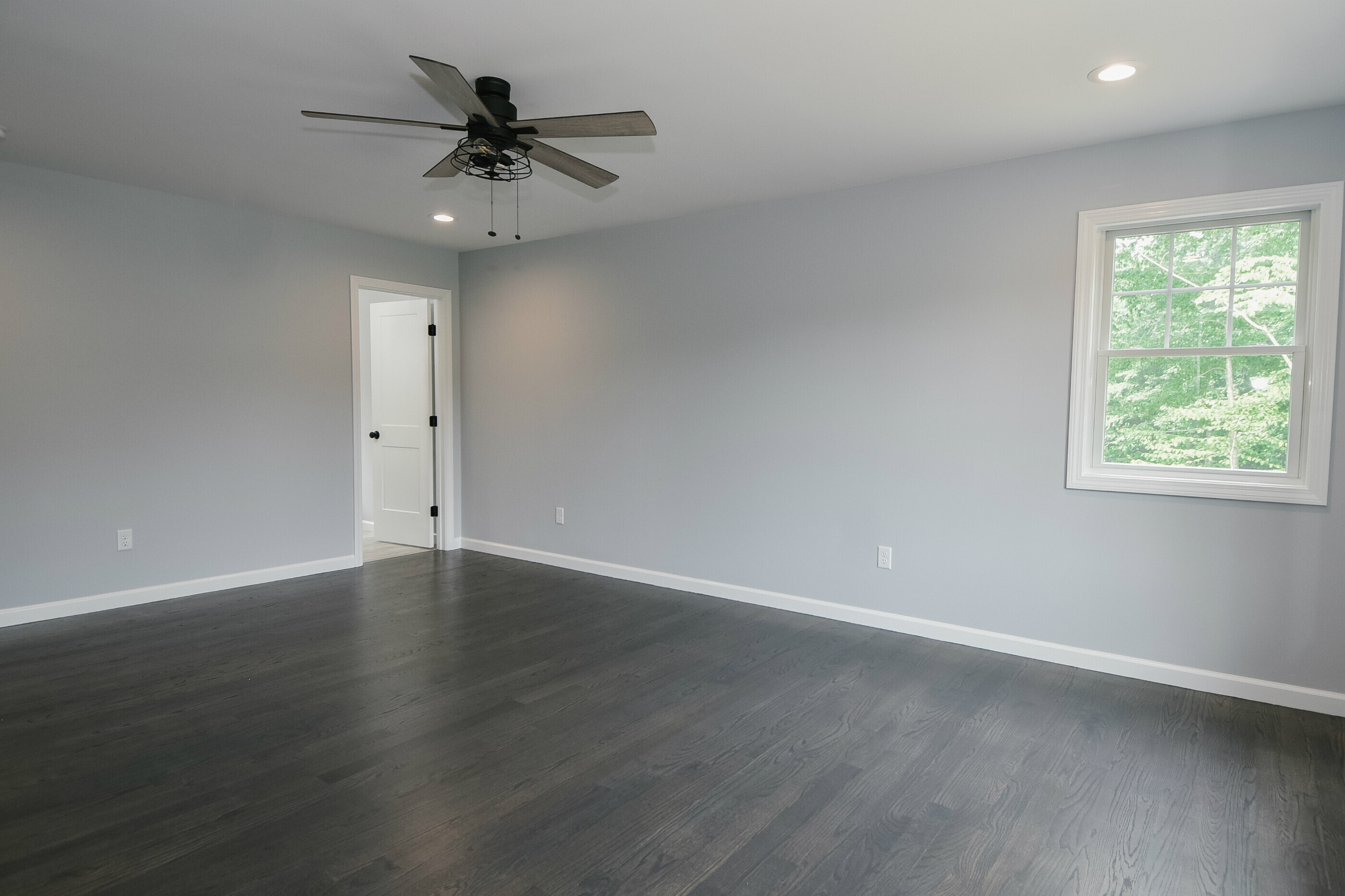 155 Old Common Road Wethersfield, CT 06109 - Photo 12 of 22 an empty room with wooden floor chandelier fan and windows