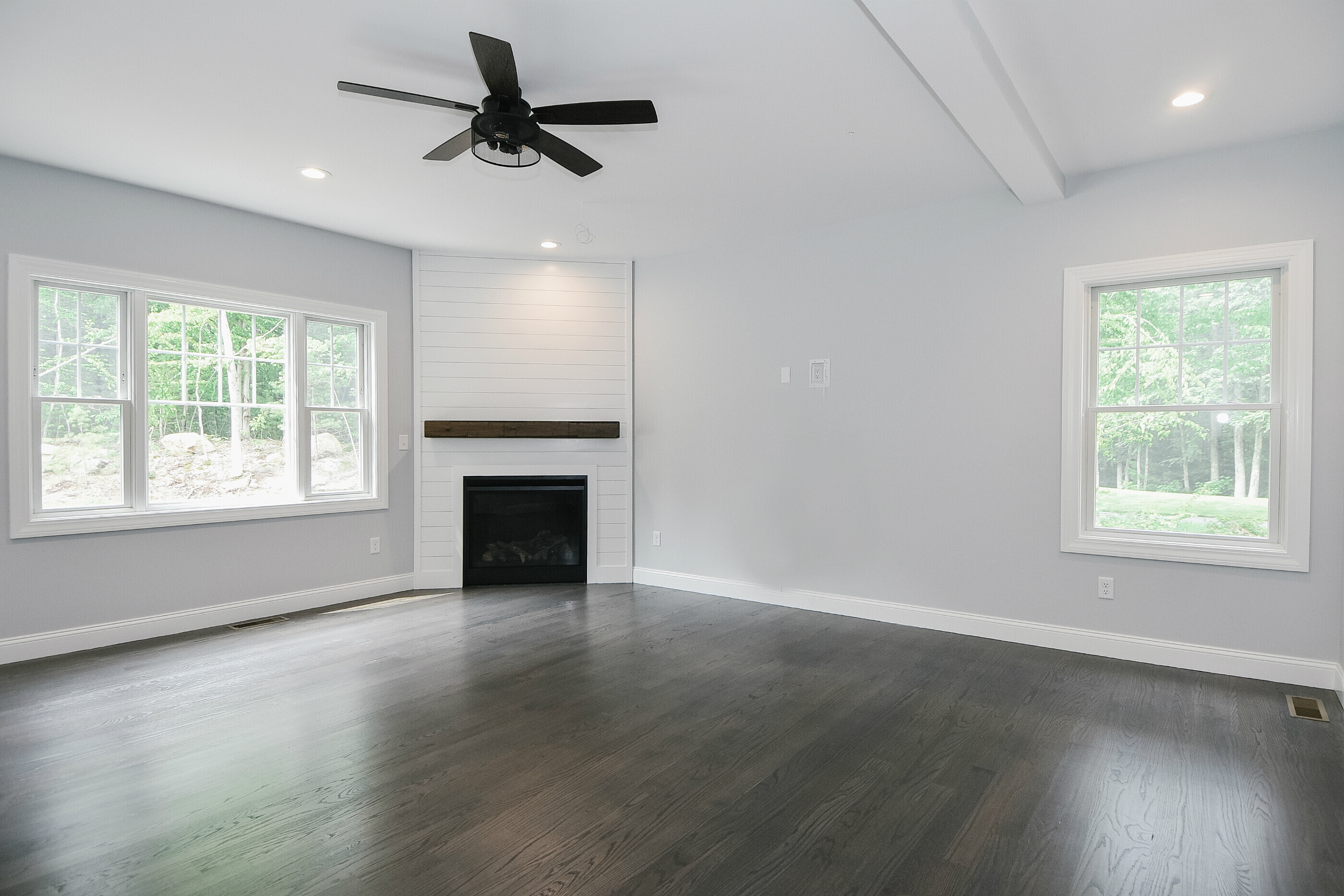 155 Old Common Road Wethersfield, CT 06109 - Photo 9 of 22 an empty room with wooden floor ceiling fan and windows