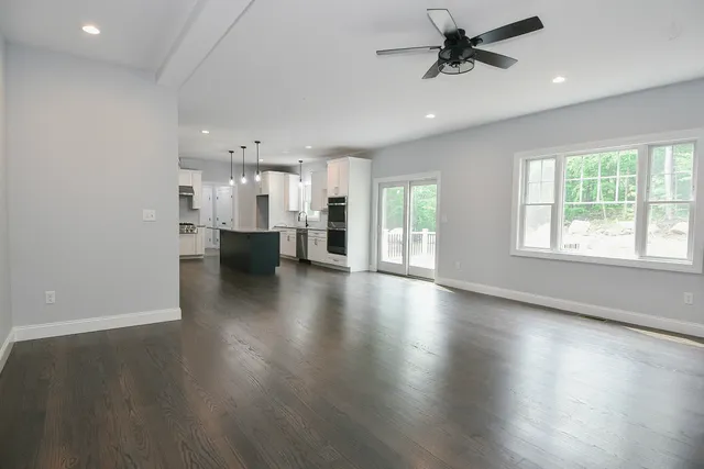 a view of a living room and kitchen with a large window