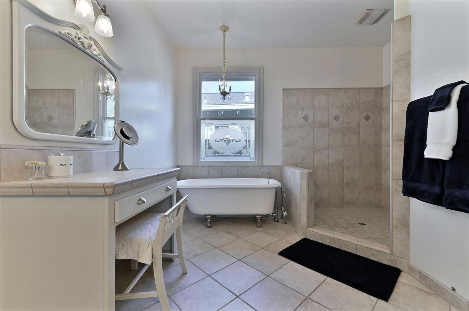 511 Surrey Lane Murphys, CA 95247 - Photo 33 of 97 a bathroom with a double vanity sink a mirror and a bathtub