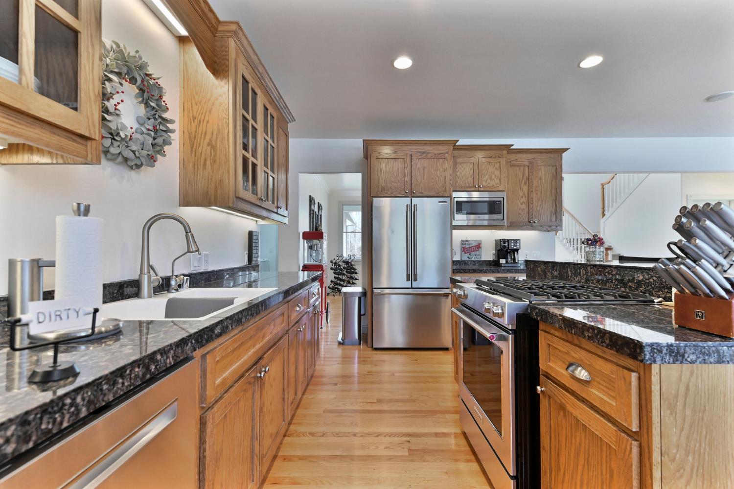 511 Surrey Lane Murphys, CA 95247 - Photo 6 of 97 a kitchen with granite countertop a sink stove and refrigerator