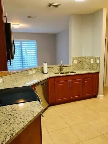 a kitchen with a sink and a stove