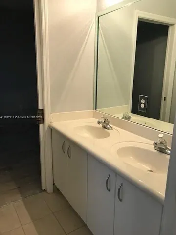 a bathroom with a sink vanity and a mirror