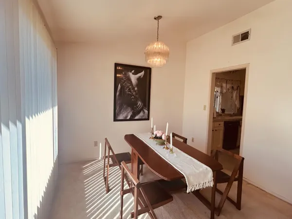 a view of a dining room with furniture and chandelier