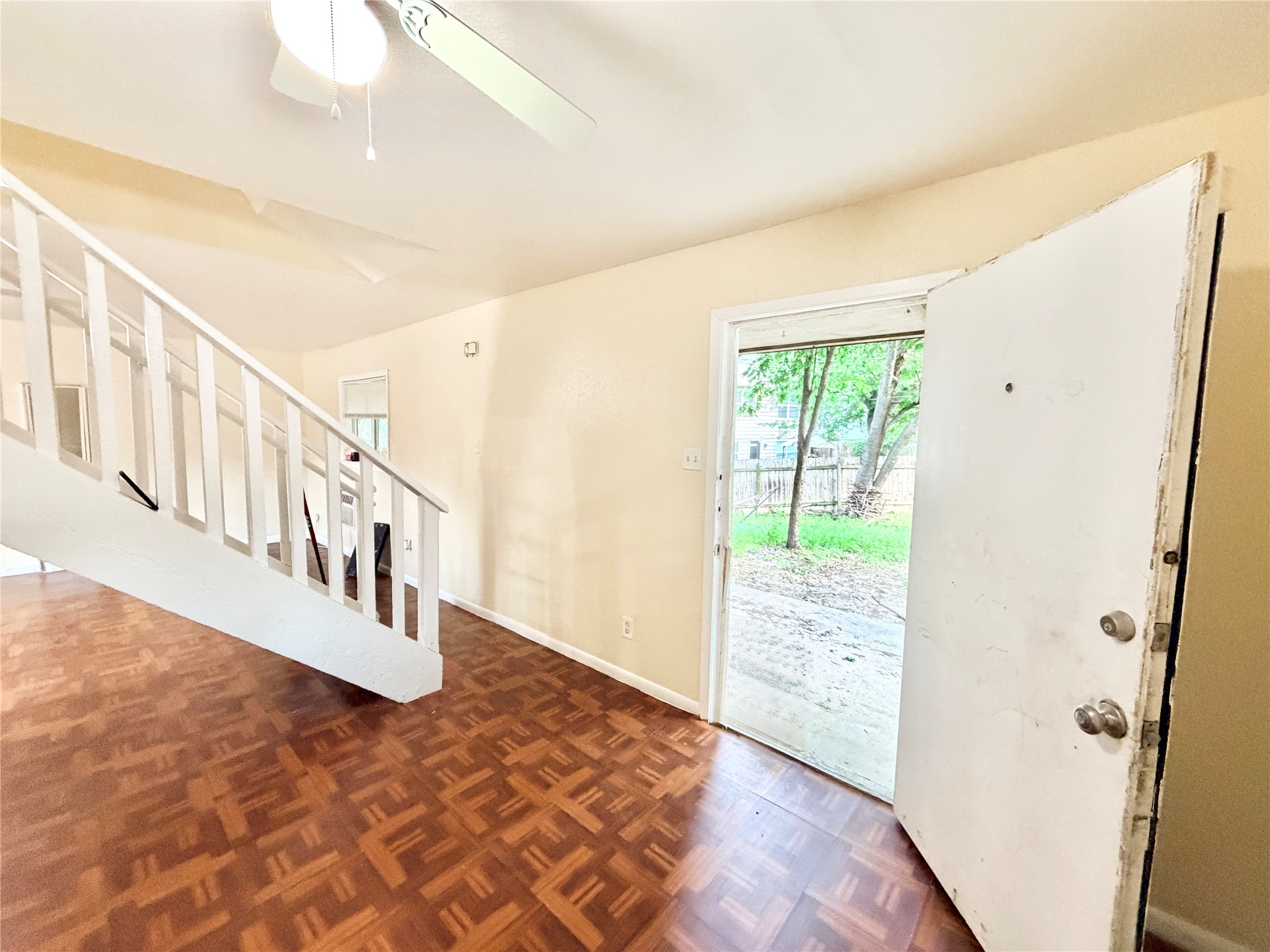 6257 Manor Road, Unit B Austin, TX 78723 - Photo 11 of 38 Interior entryway featuring wood-finish flooring, a white staircase with balusters, and a ceiling fan