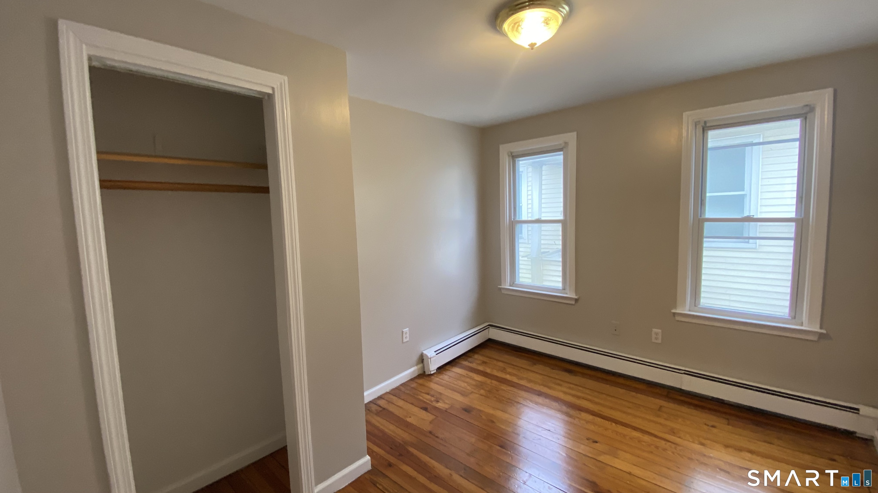 82 James Street, Unit 2 Torrington, CT 06790 - Photo 14 of 23 a view of empty room with window and wooden floor