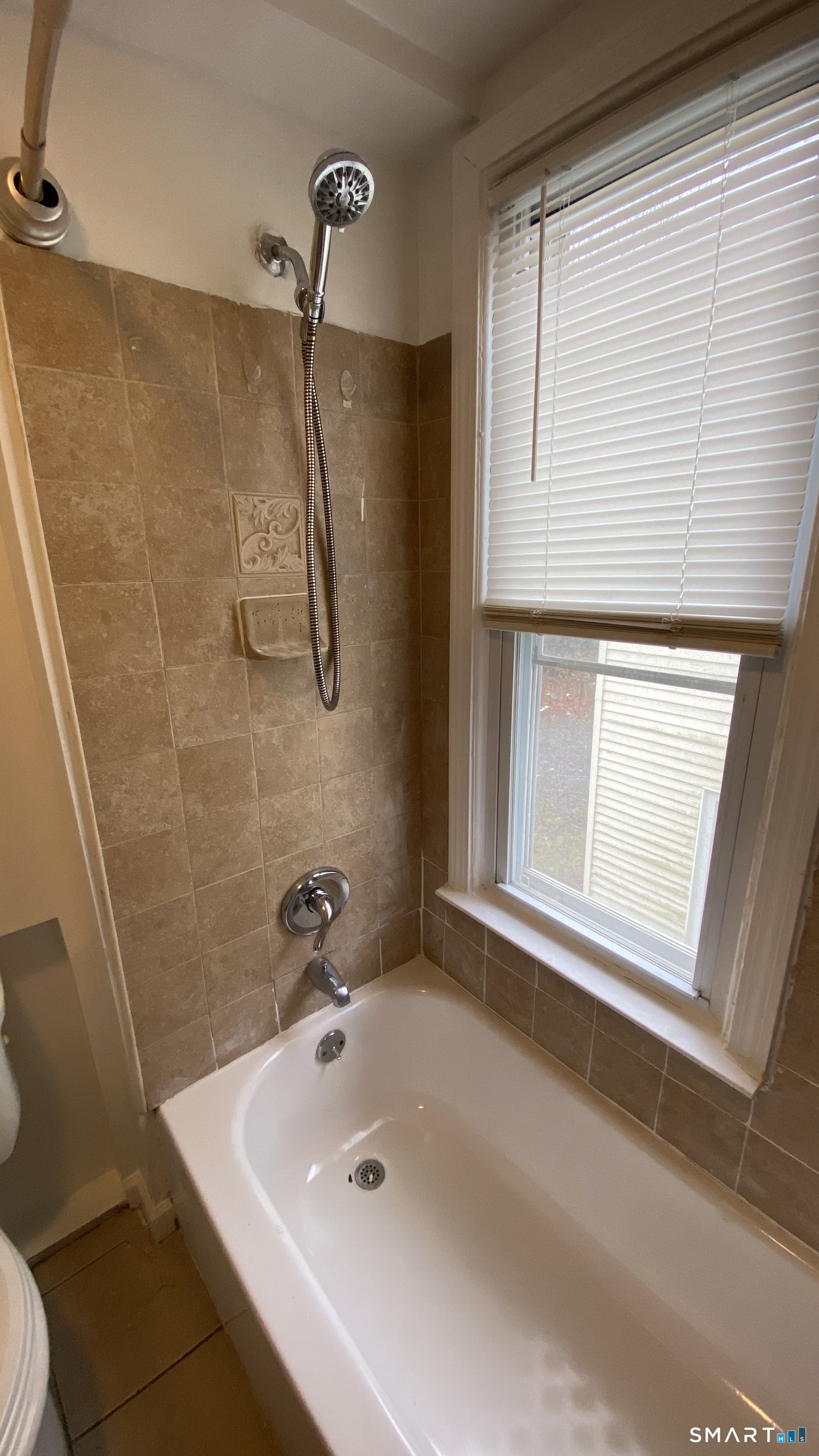 82 James Street, Unit 2 Torrington, CT 06790 - Photo 20 of 23 a bathroom with a sink a window and a shower