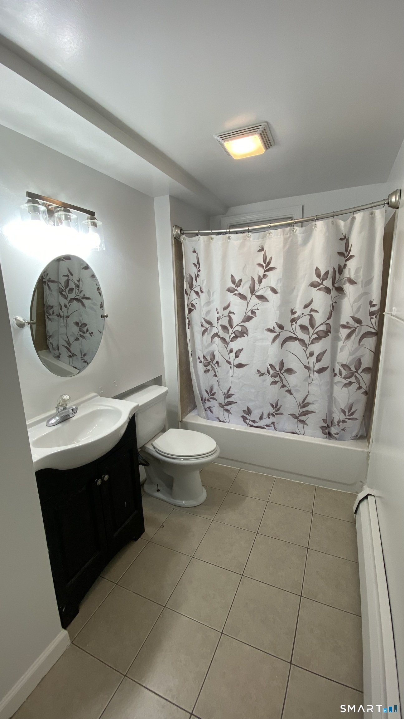 82 James Street, Unit 2 Torrington, CT 06790 - Photo 22 of 23 a bathroom with a toilet sink and mirror