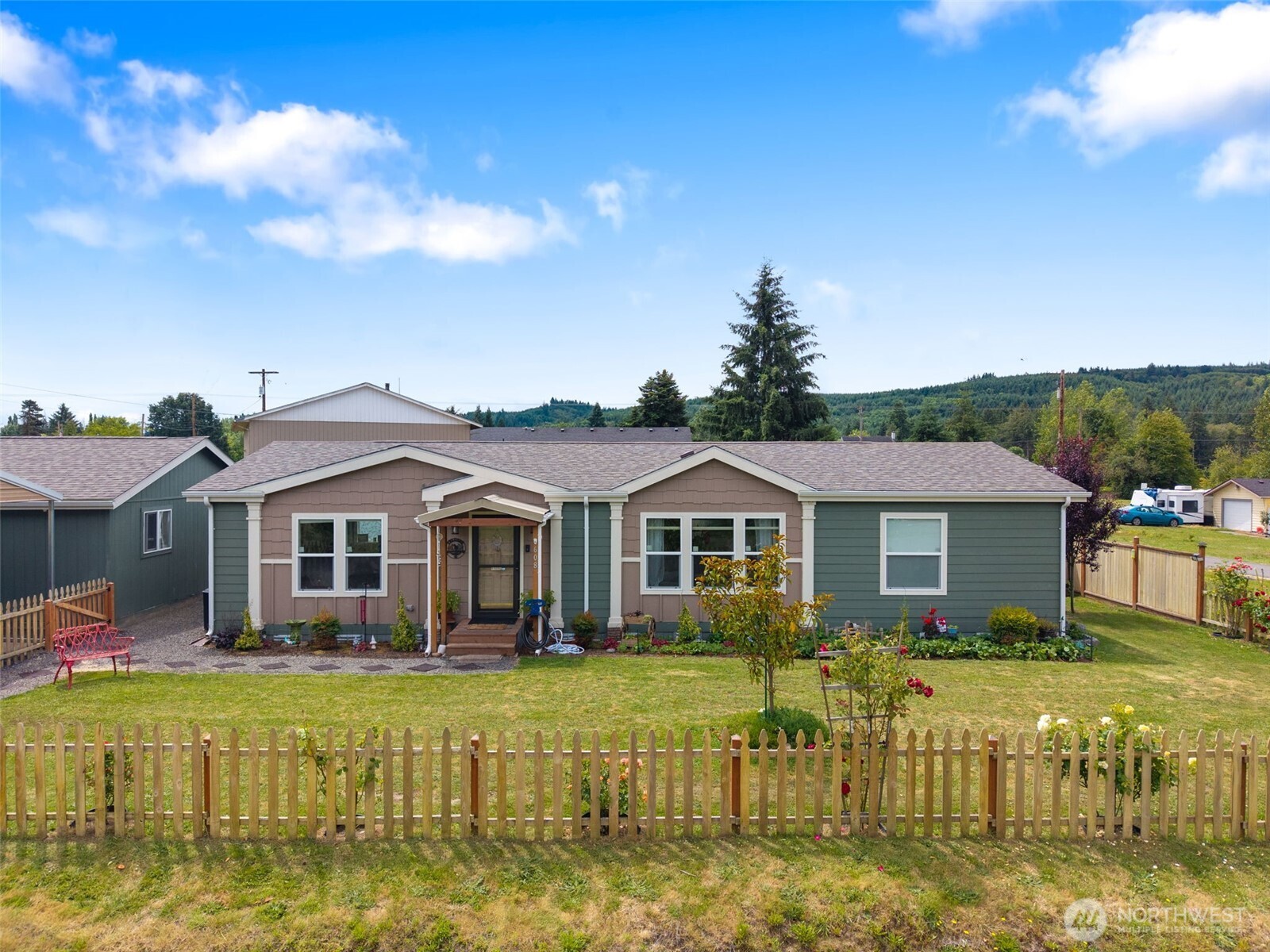 608 Main Street Vader, WA 98593 - Photo 1 of 37 a front view of a house with a yard table and chairs