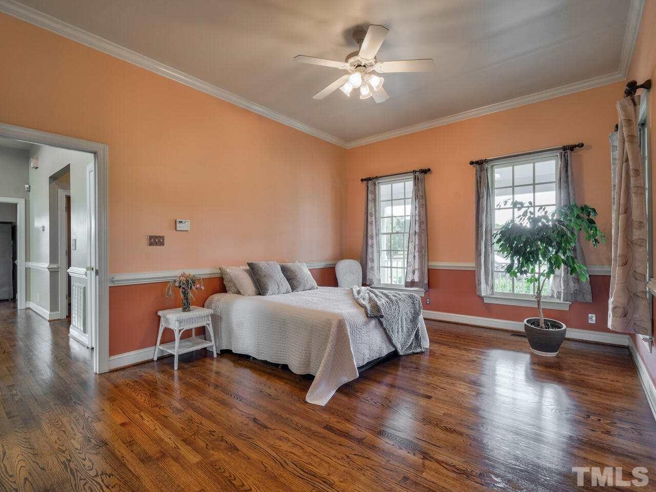 2302 Tilley Farm Road Rougemont, NC 27572 - Photo 14 of 30 a spacious bedroom with a large bed a chandelier and windows