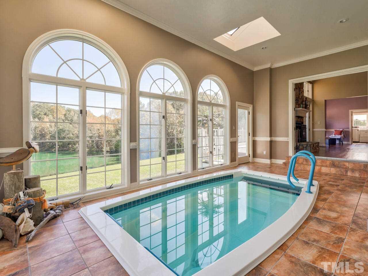 2302 Tilley Farm Road Rougemont, NC 27572 - Photo 22 of 30 a view of a swimming pool with a lounge chair