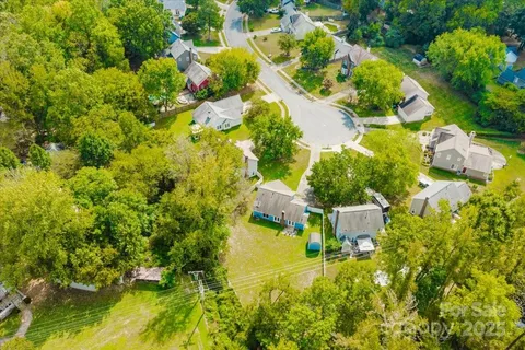 an aerial view of residential house with swimming pool and lawn chairs