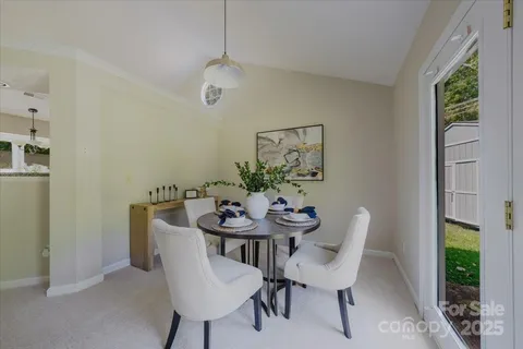 a view of a dining room with furniture and a potted plant